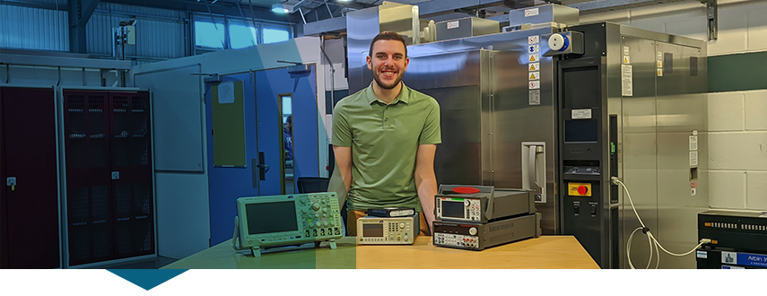 Student from Oxford Brookes poses with Tektronix tools that were used to build an electric racecar