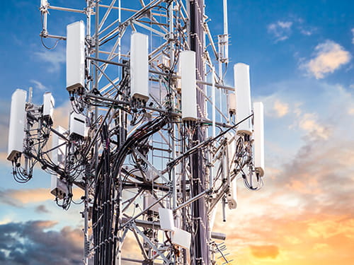 Cellular towers against blue sky for 5G Testing & Calibration
