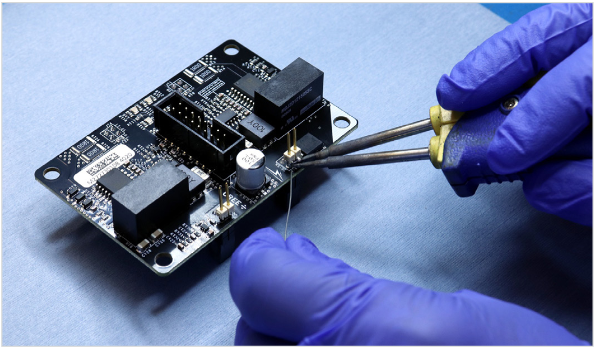 Soldering a square pin header across VGS nodes to measure high-side gate drive signal. Photo © Wolfspeed. Reprinted with permission